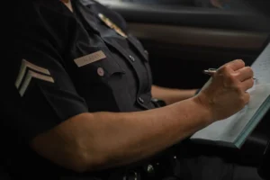 Wrong Police Report - Insider Accident Lawyers - Insider Accident Lawyers A police officer filling out a wrong police report.
